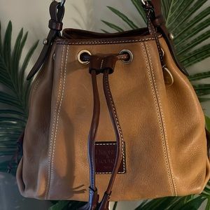 Dooney & Bourke vintage bucket bag. Cognac/tan & red interior. Lightly used.